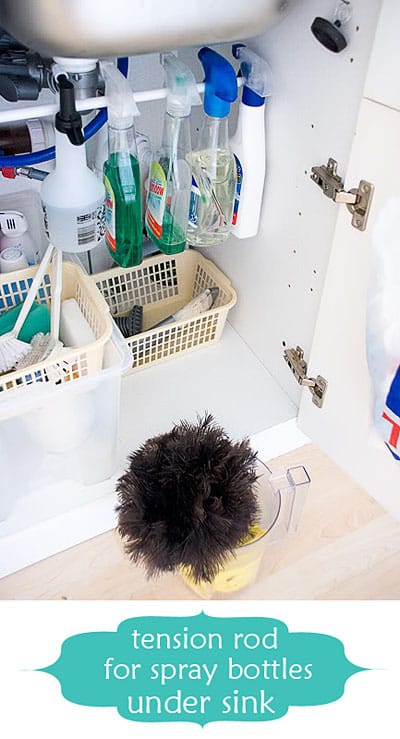 Hang cleaning supplies on a tension rod under your sink.